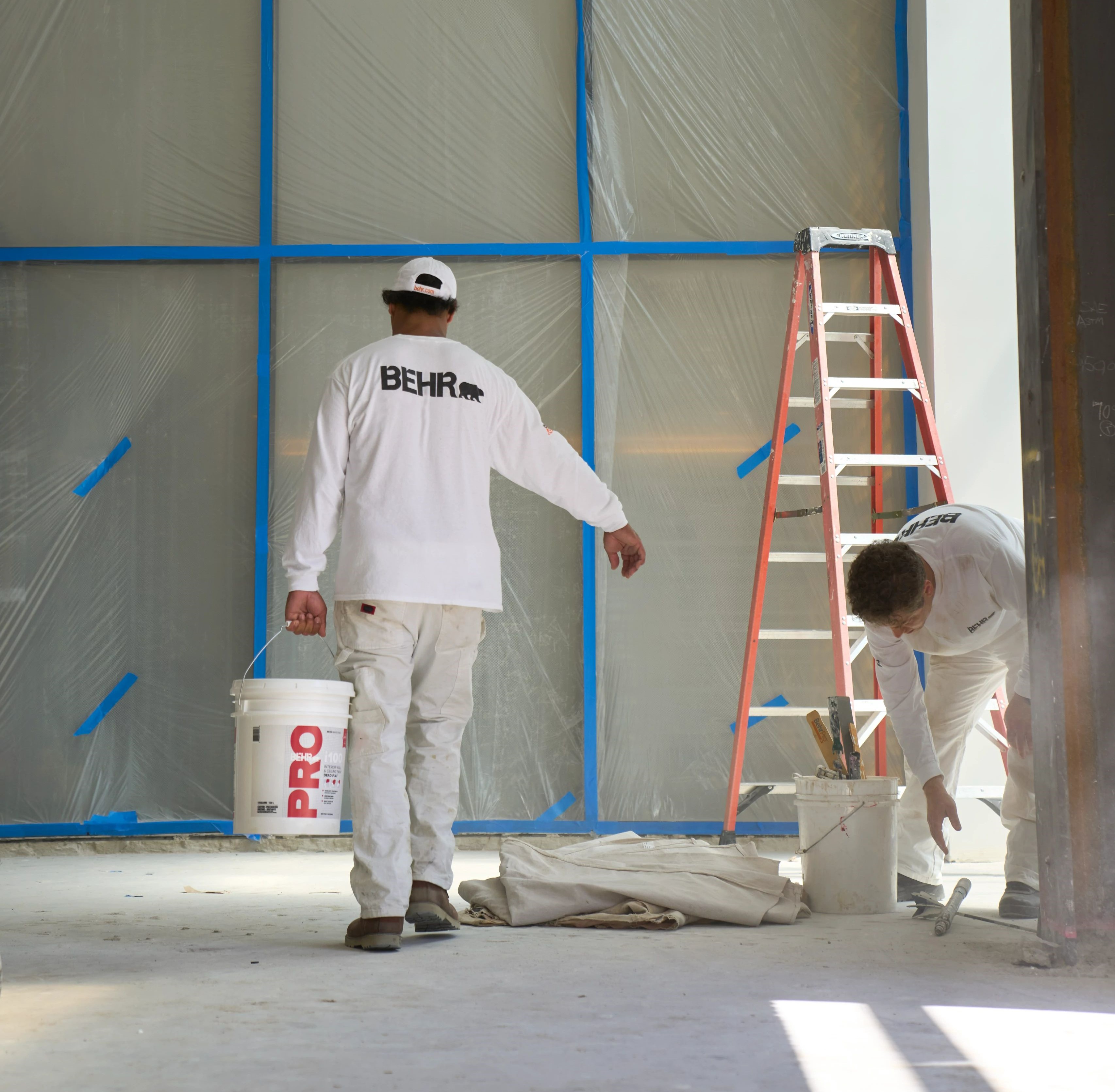 Pro painter carrying paint on a job site