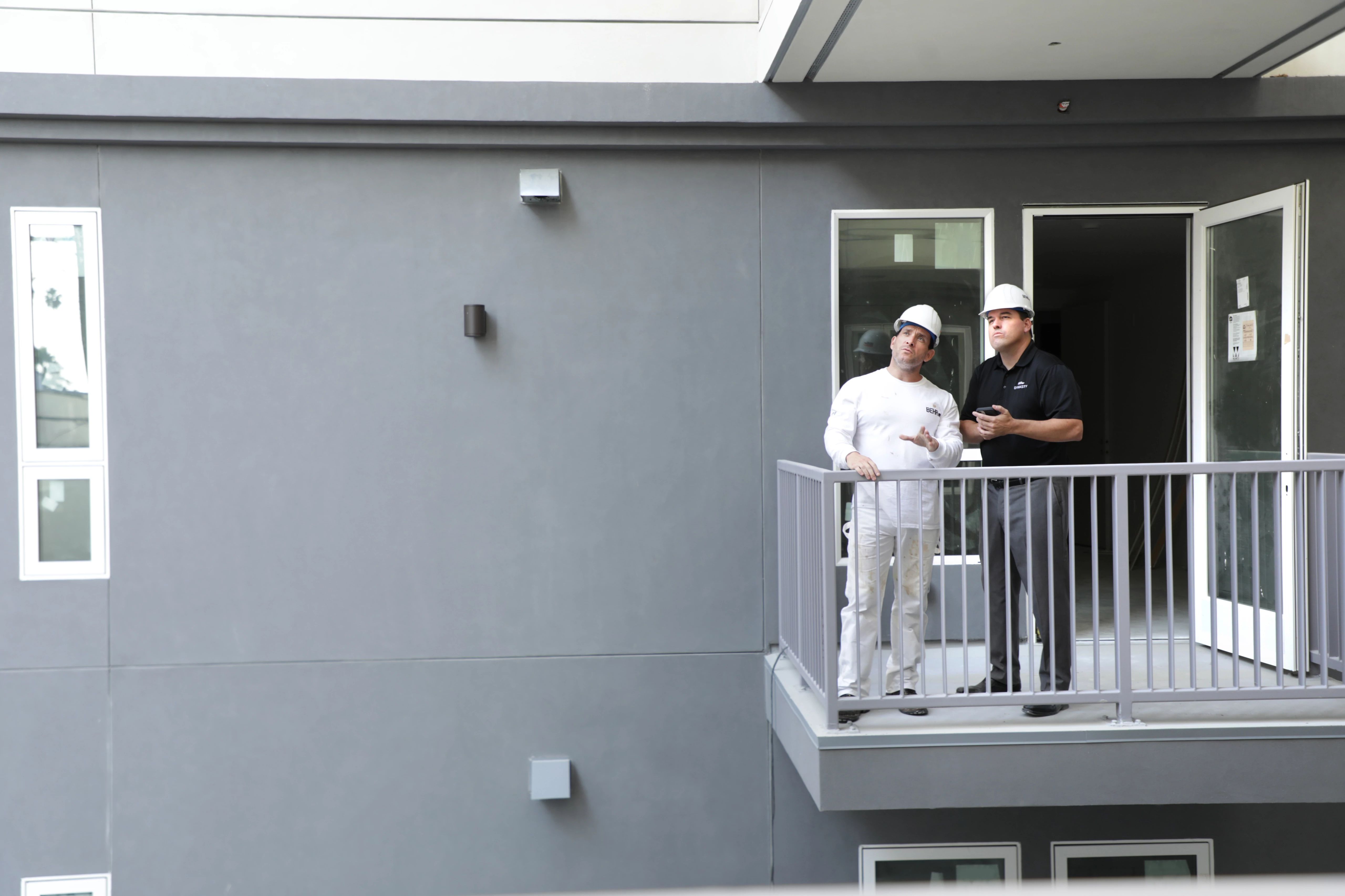 Pro painter and Rep at a job site exterior