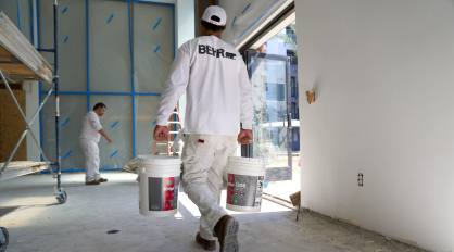 Pro painter carrying paint on a job site