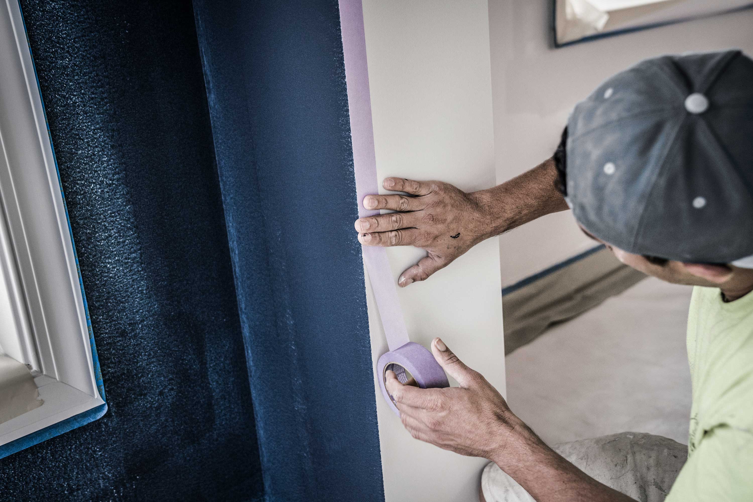 Pro painter taping wall