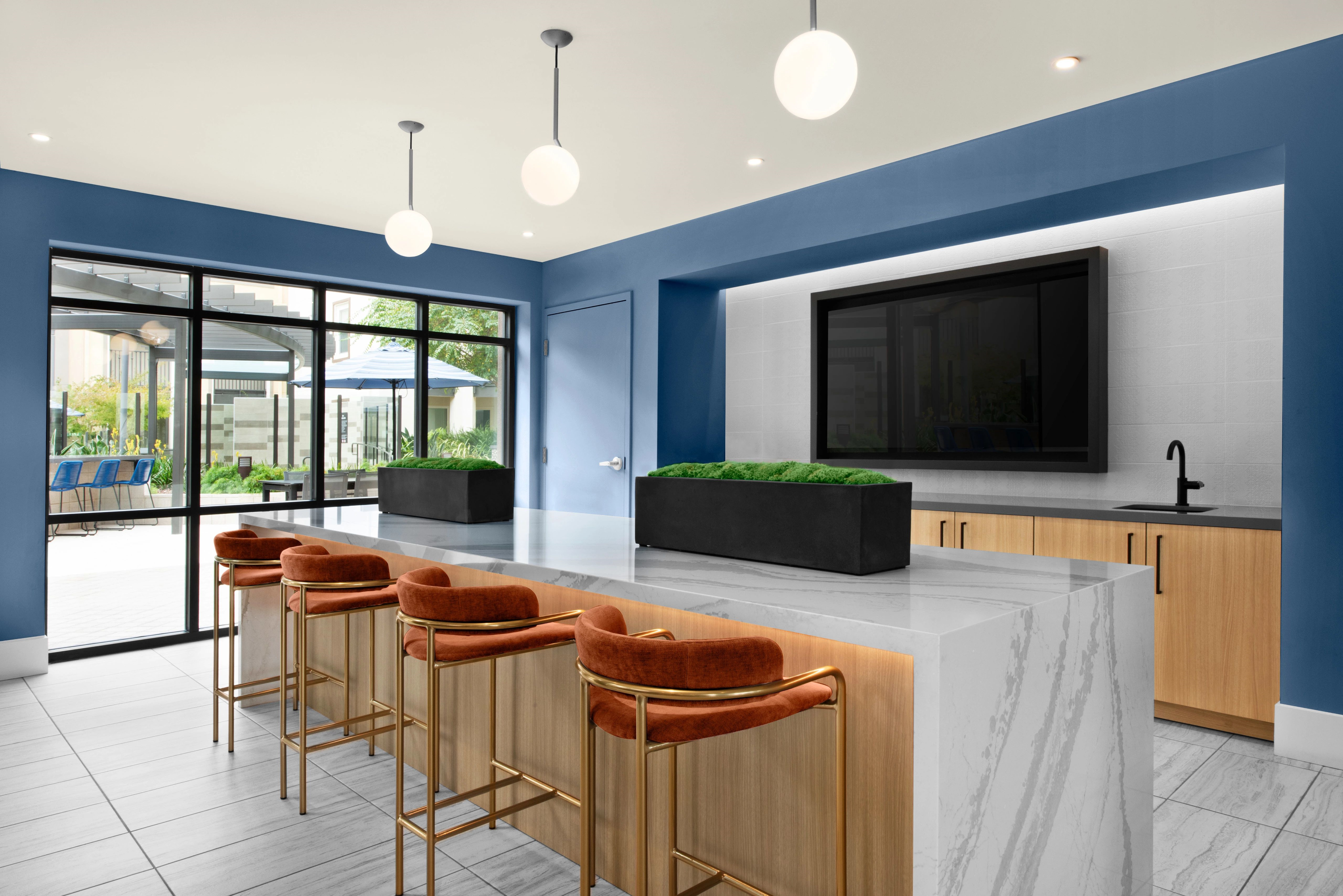 Multi-Family Lounge Featuring BEHR 2024 Trends Colors Laguna Blue and Weathered White