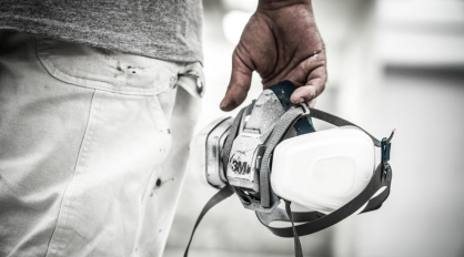 Pro painter holding a 3M respirator